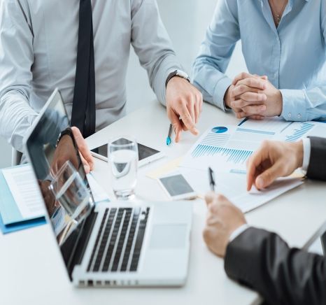 Business team planning around a laptop